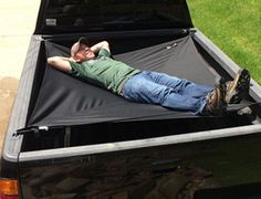 a man laying in the bed of a truck