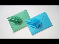 two origami envelopes sitting next to each other