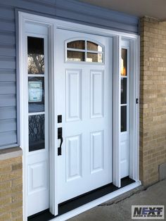 a white door with two windows on the side of a house