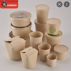 there are many cups and containers on the table