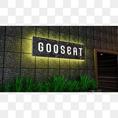 a black and white sign that says gossat on the side of a building