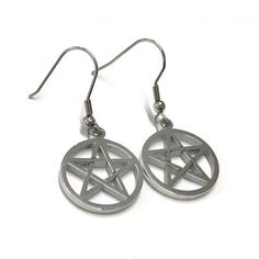 Pentacle Earrings - We're going back in time, back to our roots. For our love of the simplicity and meaning behind the pentacle. The main reason for discontinuing our previous designs was to bring you better quality - and here we have it! Our Stainless Steel Pentacle Collection. Both the hook and pendant on the Pentacle Earrings are made from Stainless Steel. Approx size of pendant: 20mm   Make sure to tag us in your pictures using #mysticumluna on Instagram so we can see how you're working the Pentacle Collection! Metal Symbolic Hypoallergenic Earrings, Gothic Surgical Steel Earrings As Gift, Gothic Star-shaped Metal Earrings, Gothic Star Shaped Metal Earrings, Gothic Silver Star Earrings, Symbolic Star-shaped Nickel-free Earrings, Silver Star Gothic Earrings, Symbolic Nickel-free Star Earrings, Nickel-free Star Shaped Symbolic Earrings