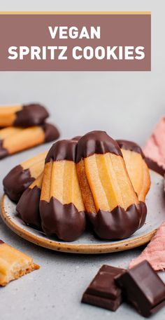 vegan spritz cookies on a plate with chocolate