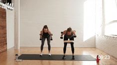 two women doing exercises with dumbbells in an empty room