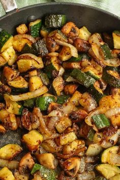 a pan filled with cooked vegetables on top of a table