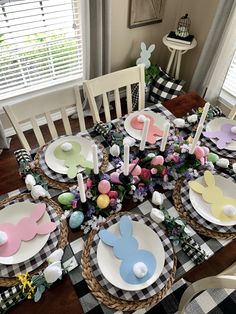 the table is set for easter dinner with plates and napkins