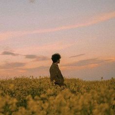 a man standing in a field looking at the sky