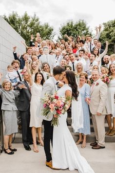 a group of people that are standing in front of some stairs with flowers on them