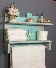 a shelf with towels and seashells on it