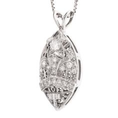 This beautiful pendant is a striking combination of filigree and diamonds, and though it's relatively large (30mm x 13mm), the filigree and the cutouts help create a delicateness. At the top of the pendant is a 3.2mm diamond set into the middle of a white gold star. Ideally suited to hang from a white gold chain (not included), this pendant is a real conversation starter! The design is attributed to the Amaranth Matron, which is the highest rank in the Order of the Eastern Star, an organization Art Deco Diamond Necklace With Filigree Details, Art Deco Diamond Necklace With Filigree, Oval Diamond Filigree Necklace, Diamond Filigree Pendant Jewelry, Filigree Diamond Pendant Jewelry, Oval Diamond Necklace With Intricate Design, Oval Diamond Filigree Jewelry, Diamond Filigree Necklace In Fine Jewelry Style, Diamond Filigree Necklace As Gift