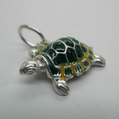 "This three-dimensional, sterling silver Turtle charm is exquisitely hand-enameled in green, yellow, black, and silver. \"Slow Poke\" is inscribed on his belly. Vintage and in brand new, never worn condition. Made by Brown County Silver. 7/8\" long 3.8 grams See more @ https://www.etsy.com/shop/brocosi" Green Jewelry With Black Enamel As A Gift, Green Jewelry With Black Enamel For Gift, Green Enamel Charm Jewelry, Green Enamel Jewelry With Charms, Green Enamel Jewelry With Polished Finish, Silver Enamel Jewelry Souvenir, Brown County, Turtle Jewelry, Turtle Bracelet