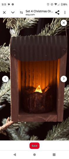 an ornament hanging from a christmas tree with a lit fireplace in the middle