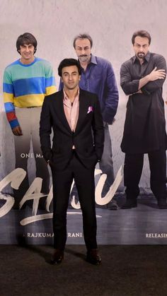 a man standing in front of a movie poster