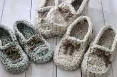 four crocheted baby shoes are laying on the floor next to eachother