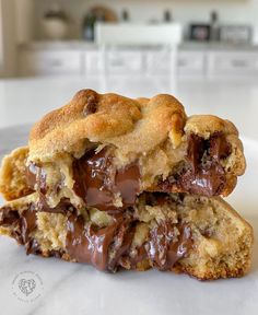 two chocolate chip cookies are stacked on top of each other