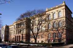 an old building with cars parked in front