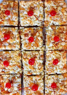 several squares of food with cherries and nuts on them are arranged in a square pattern