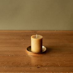 a small candle sitting on top of a wooden table