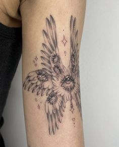 a woman's arm with an owl tattoo on it