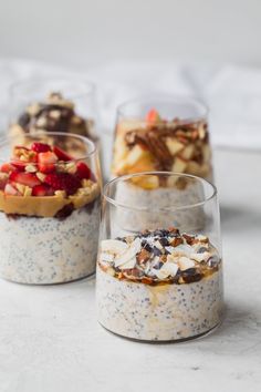 three desserts in glass cups with fruit and nuts on the top one is filled with oatmeal