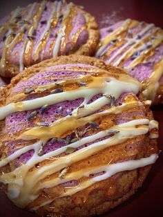 three cookies with icing and sprinkles sitting on top of each other