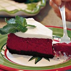 a piece of cake on a plate with a fork in it and someone holding a knife