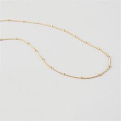 This simple, tiny, short beaded chain necklace is the perfect base to start layering your necklaces. It's very short, but not quite choker length, so it won't get lost within your other pieces. However, this is also a great necklace to wear alone with a higher collar dress or tee! It lays beautifully on top of your collar bone. *Please keep in mind that this necklace will be a little shorter or longer on your depending on the circumference of your neck. DETAILS & SIZE Composition: 18K gold p Delicate Choker Necklace With Satellite Chain, Delicate Satellite Chain Choker Necklace, Minimalist Beaded Chain Layered Necklace, Minimalist Everyday Beaded Chain Layered Necklace, Minimalist Tiny Beads Chain Necklace For Everyday, Minimalist Beaded Necklace With Delicate Adjustable Chain, Everyday Tiny Beads Choker, Minimalist Adjustable Beaded Necklace With Delicate Chain, Minimalist Layered Choker Necklace