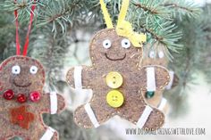 two ginger ornaments hanging from a christmas tree