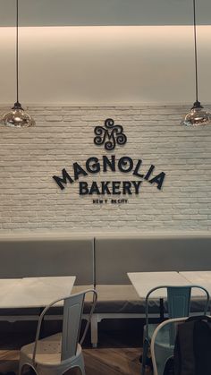 the interior of an italian bakery with white brick walls and chairs in front of them