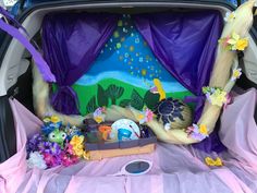 the trunk of a car is decorated with flowers and seashells