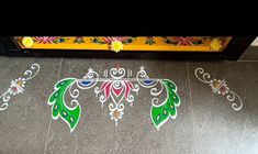 the floor is decorated with colorful flowers and leaves, while an ornate frame stands in front of it