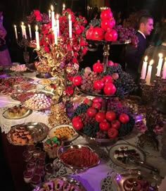 a table filled with lots of food and candles