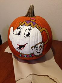 a pumpkin decorated with an image of beauty and the beast