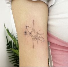 a woman's arm with a star tattoo on it