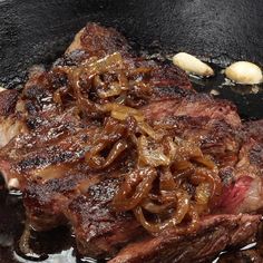 steak with onions cooking in a skillet