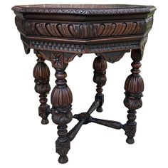 an ornate wooden table with carvings on the top and legs, is shown in front of a white background