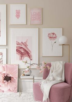 a living room with pink furniture and pictures on the wall