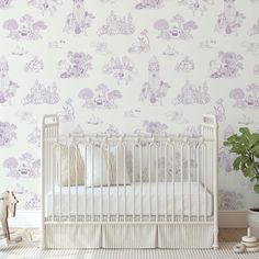 a baby crib in front of a wall with purple and white designs on it