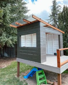 a small wooden structure with a roof made out of wood and some plastic toys on the ground