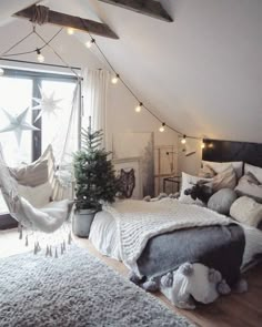 a bedroom with a hammock hanging from the ceiling and lights on the windowsill