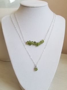 Peridot: The birthstone for August. A crystal rich in culture, mysticism and healing power. A stone that helps to boost the confidence of those wearing it, as well as attracting luck, love & wealth. Brings peace & harmony to one's life. TWO Piece Necklace Layering Set! Gorgeous raw green Peridot is elegant yet rustic. This is a two piece layering necklace set. Your choice of Sterling Silver or Gold Filled. Solid lobster claw clasp. Details: * Natural raw Perdiot nugget chips Size: Betwee Spiritual Peridot Jewelry With Gemstone Accents, Spiritual Peridot Jewelry With Gemstone, Spiritual Peridot Gemstone Jewelry, May Birthstone Crystal Necklace For Healing, Spiritual May Birthstone Crystal Necklace, Peridot Gemstone Beads Necklace As Gift, Peridot Gemstone Beads Necklace For Gift, Peridot Gemstone Bead Necklace For Gift, Peridot Jewelry With Natural Stones For Healing