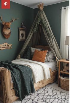 a bed with a canopy and pillows on top of it in a room that has green walls