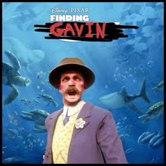 a man in a suit and hat standing in front of a poster for finding gavin