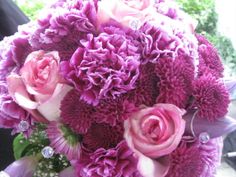 a bridal bouquet with pink and purple flowers