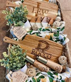 a basket filled with wooden utensils and personalized napkins on top of a table