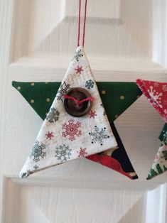 an ornament hanging from the side of a door decorated with fabric and buttons