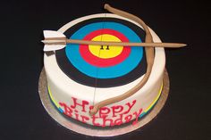 a birthday cake with an arrow and bow on it