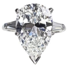 an oval cut diamond ring with three baguets