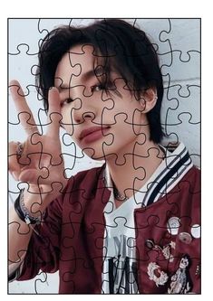 a person making a peace sign in front of a puzzle piece wall with the word love written on it