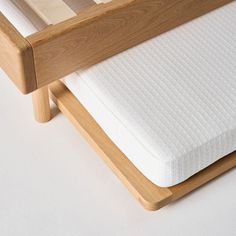 a close up of a bed frame with a mattress on the bottom and back side